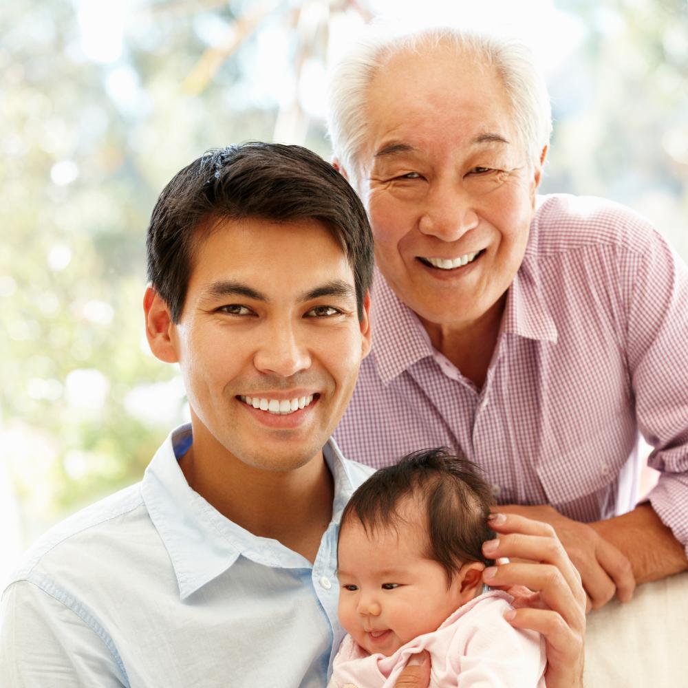 Smiling grandfather, son, and baby grandson.